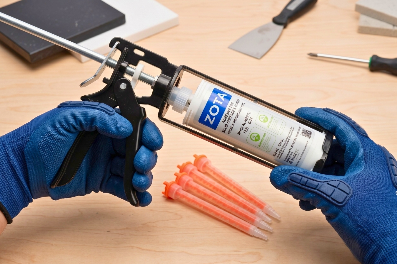 Loading a ZOTA adhesive cartridge into a manual dispensing gun; Marktec provides professional countertop fabrication tools and high-strength bonding glues for stone and solid surfaces.