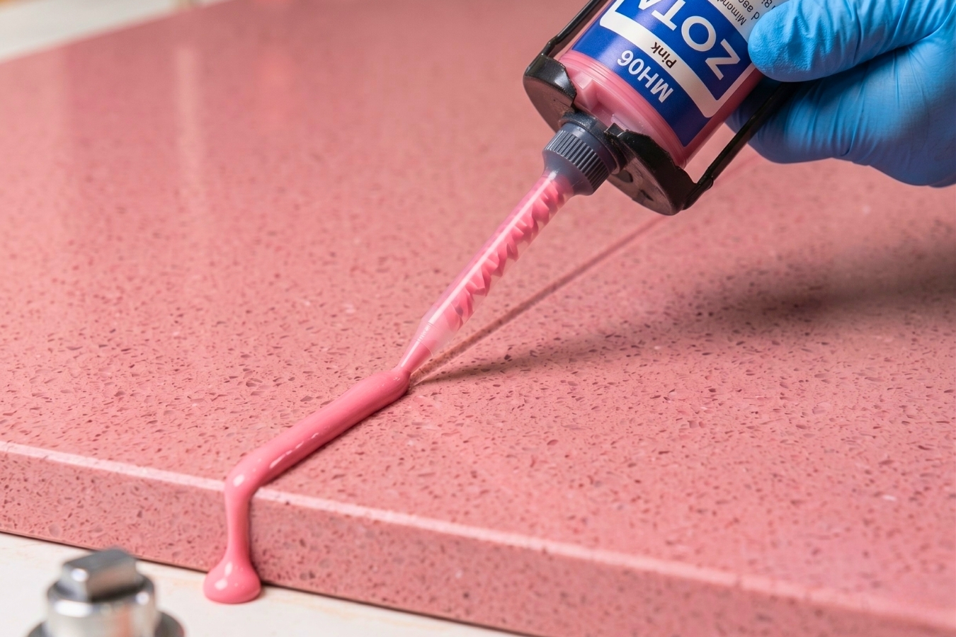 Applying ZOTA MH06 Pink adhesive to a matching speckled quartz countertop; Marktec professional bonding glue for seamless kitchen and bathroom surface fabrication.